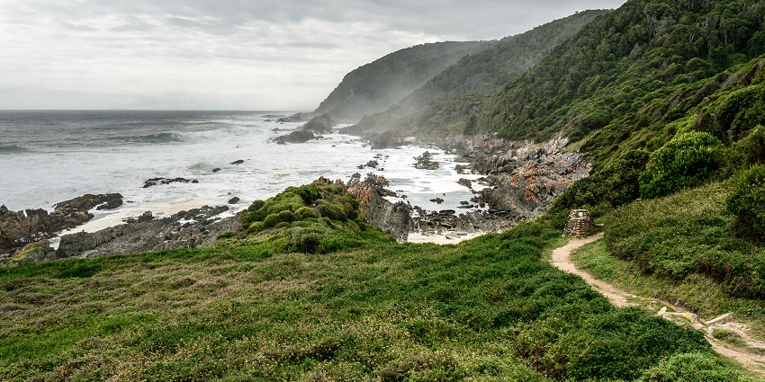 Image of the roadway leading to Tsitsikamma National Park surrounded by beautiful mountains