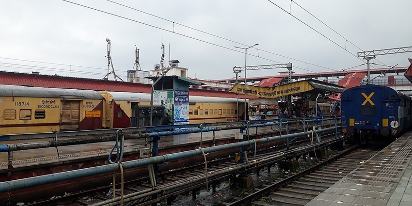 New Jalpaiguri Junction with multiple platforms, trains and a shop on the platform