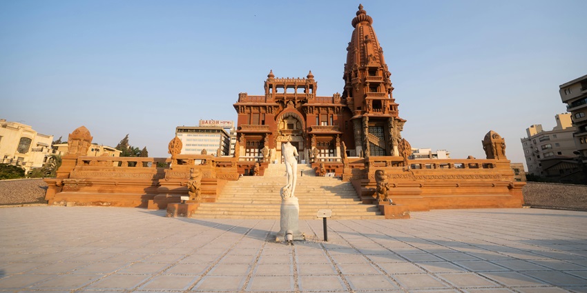 A picture of the entrance of Baron Empain Palace, inviting tourists to explore its history.