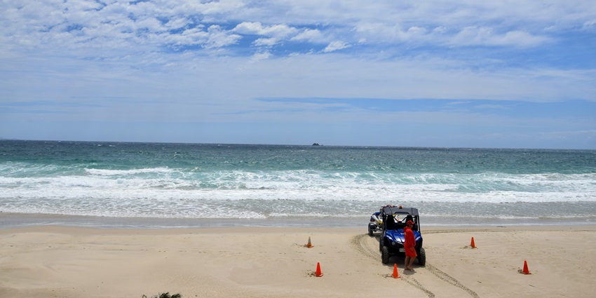 Scenic view of the Byron bay, waves crashing and the clear bright sky above it