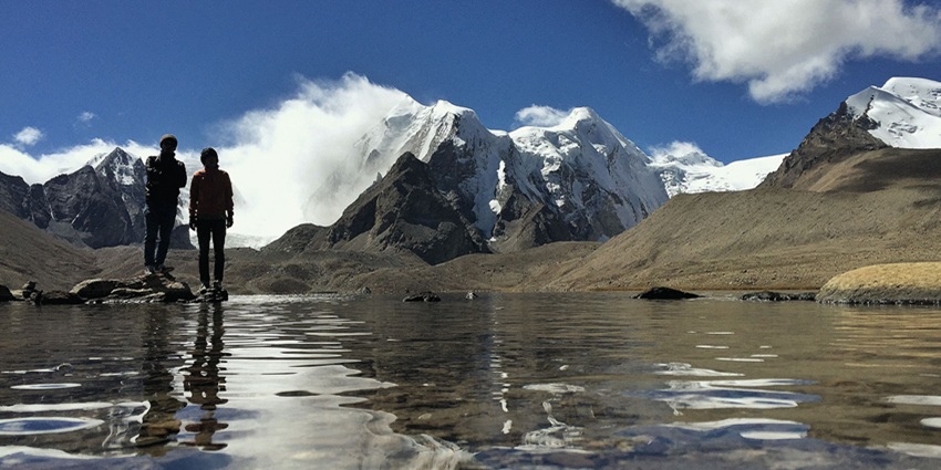 A stunning view of Gurudongmar Lake in December, with snow-capped peaks in the heritage.