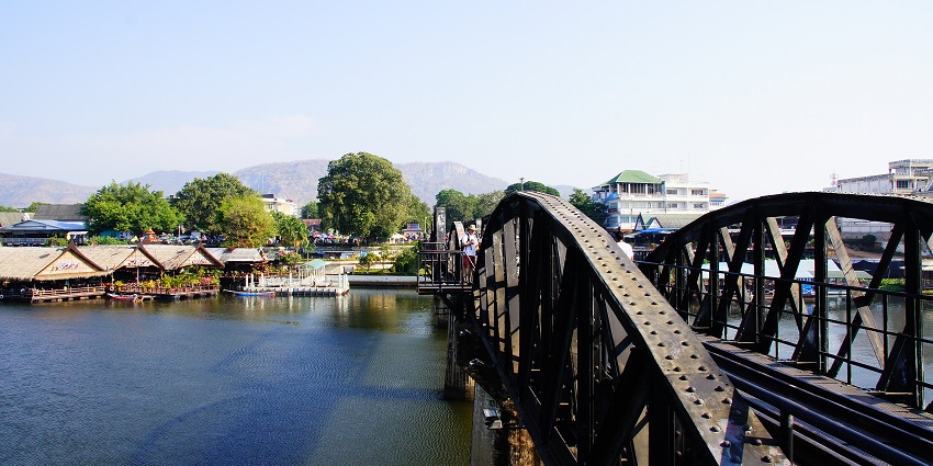 Image of the iconic bridge in the town surrounded by houses and lush greenery