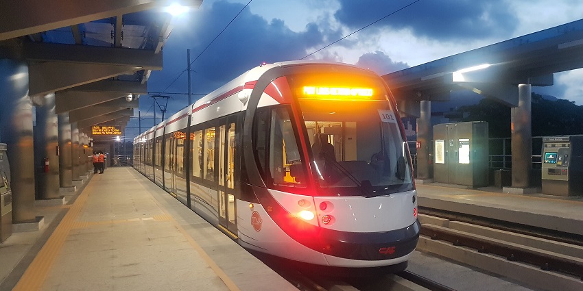 An image of a modern white train at a cloudy urban station in Rose Hill, Mauritius.