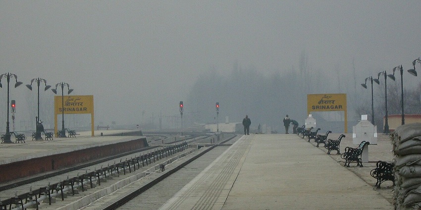 Srinagar railway station with two train platforms, sign boards and benches on the platform