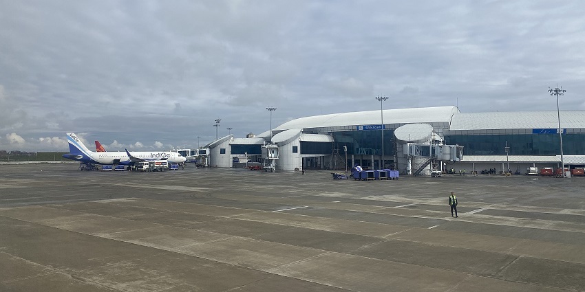 Sheikh ul-Alam international airport with an airplane connected to the boarding bridge