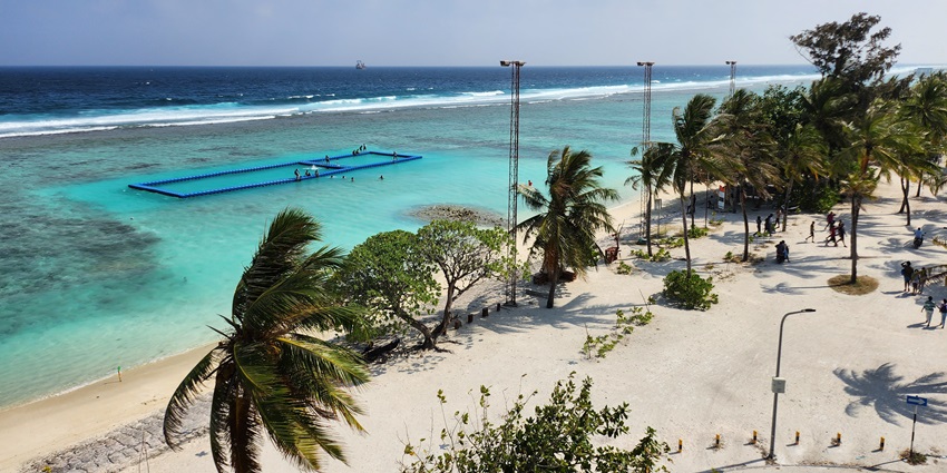 Gentle waves rolling onto the pristine coastline of Hulhumale Island in Maldives.