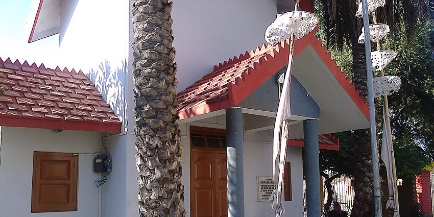 Entrance to the INA memorial with white and red architecture and stairs at the entrance.
