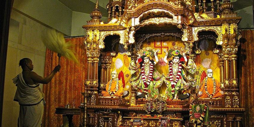 A priest worshipping the majestically decorated idols of Radha-Krishna at the ISKCON temples in Russia.