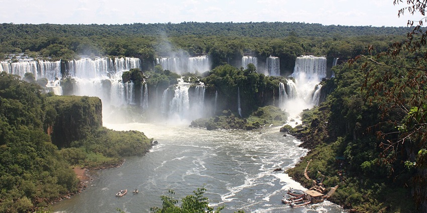 Scenic yet powerful Iguazu Falls, showcasing cascading waterfalls with lush greenery.