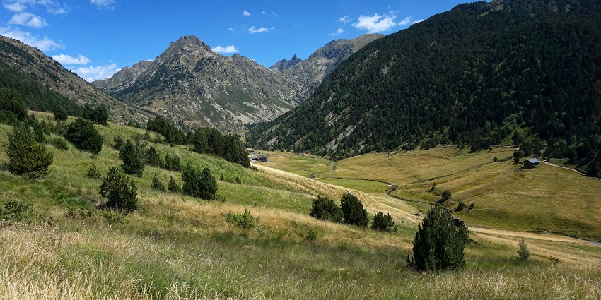 Green valleys are stretching between mountains while gentle winds are blowing steadily