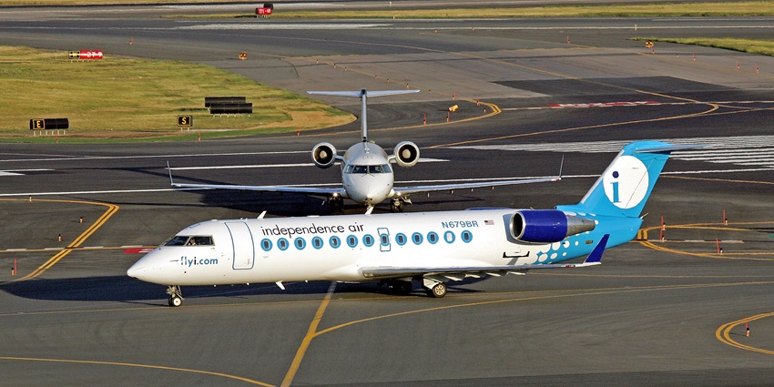 Independence aeroplanes parked on the runway with yellow markings and green plains