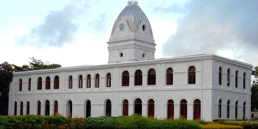 An image of a white colonial-style building of Independence Square, with a clock tower