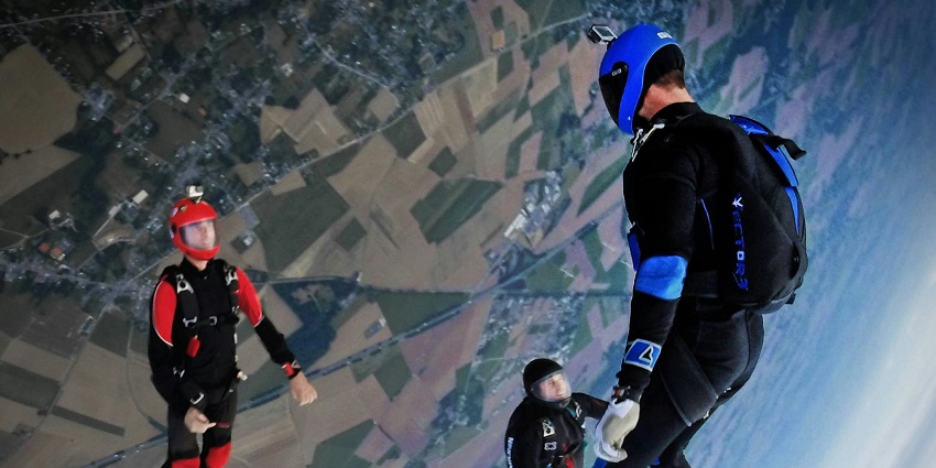 Image of three sky divers in the sky during an exciting skydiving in Europe