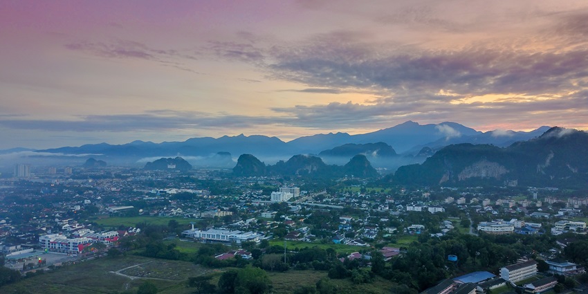 A scenic view of Ipoh city, showcasing its urban landscape and surrounding hills.