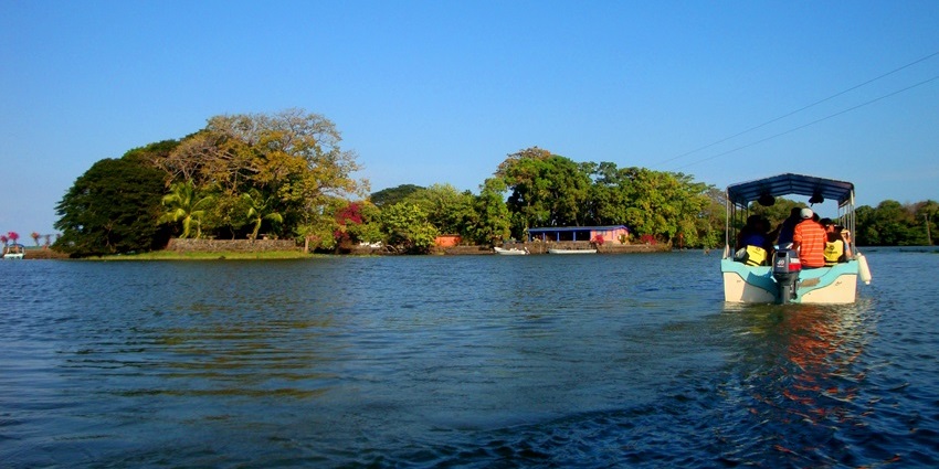A scenic view of Isletas de Granada, showcasing tranquil waters, lush greenery, and scattered tropical islets.