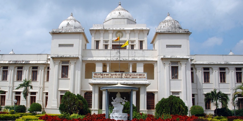 White colonial-style building of Jaffna Public Library with pillars and a grand entrance.
