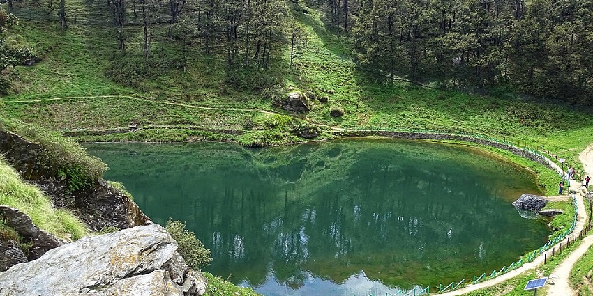 Jalori pass, Serolsar lake with a small green water body surrounded by greenery and trees
