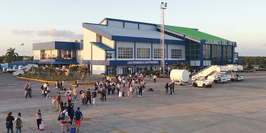 Terminal building of Jardines del Rey airport with architecture and lots of passengers