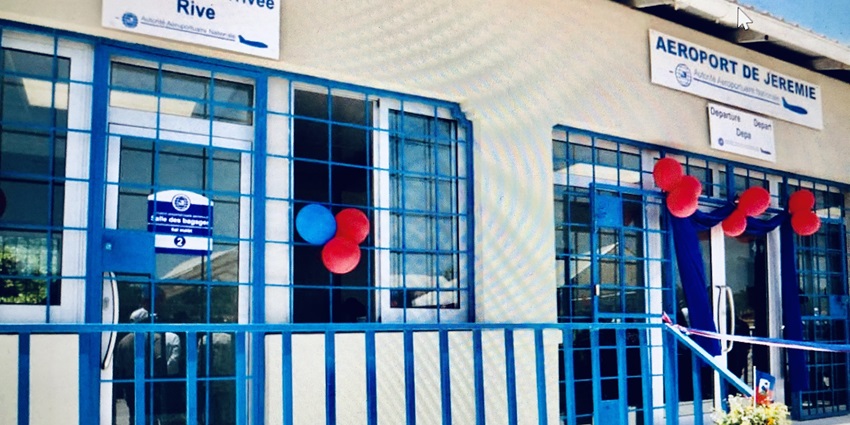 Entrance of Jeremie Airport with a blue and white design, showcasing the terminal's facade