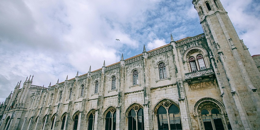 A view of the Jeronimos Monastery under a blue sky, one of the places to visit in Portugal