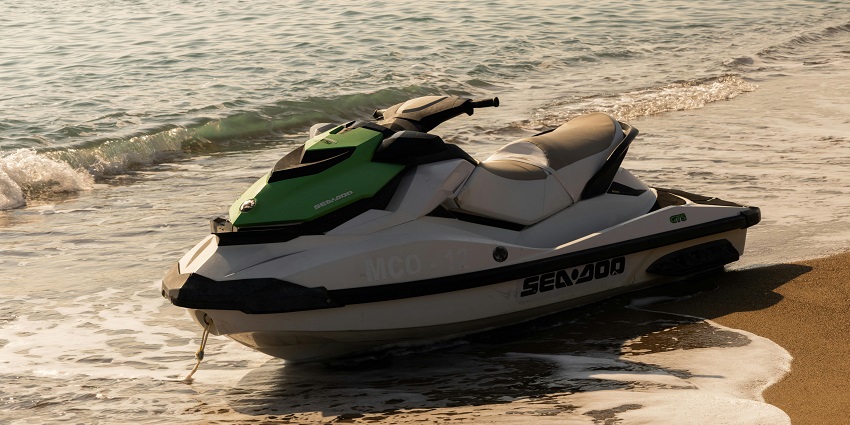 An image of Jet Ski Safari, at the beach shore, with gentle waves and jet skis on water.