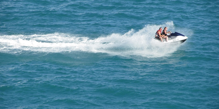 An image of a person riding a jet ski similar to the Morjim Beach water sports.