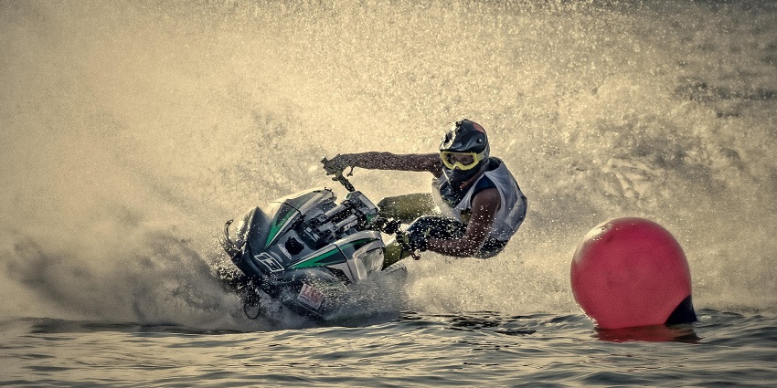 An image showing a jet ski and motor boat race, highlighting famous water sports in Konkan.
