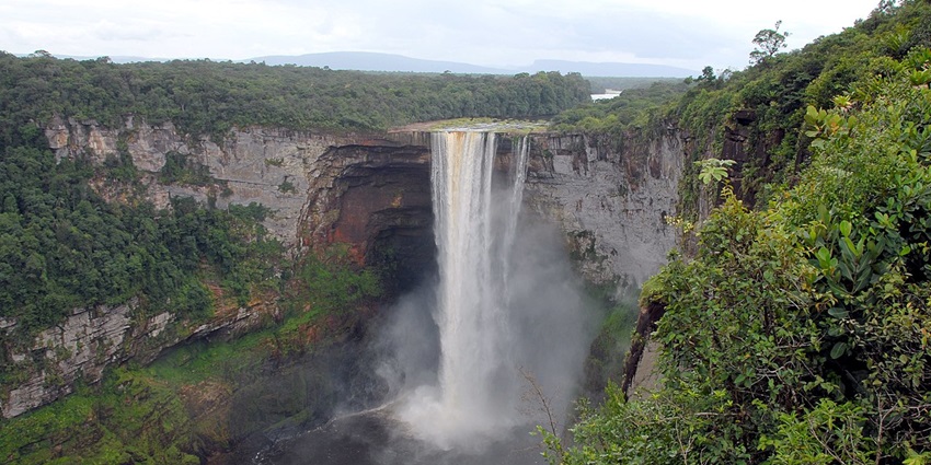 Kaieteur Falls on the Potaro River in Guyana featuring azure waters and lush greenery.