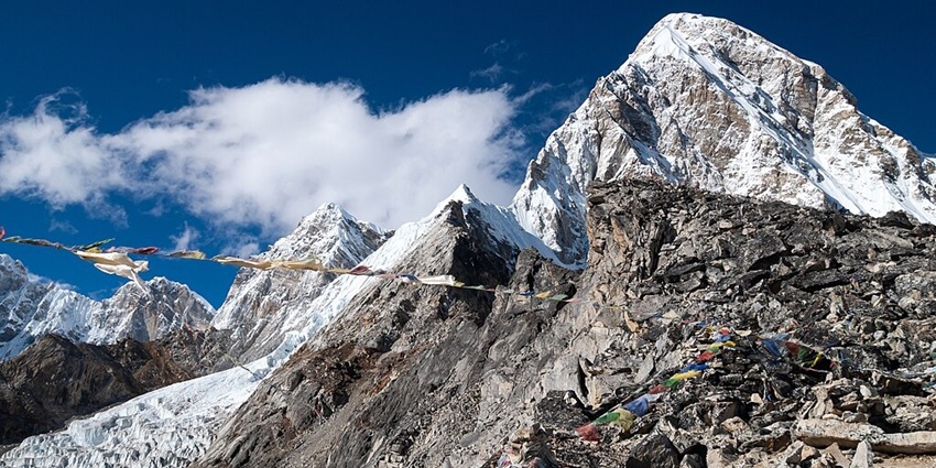 Mount Pumori in Kala Patthar with rocky mountain, snowy mountain peaks and Tibetan flags