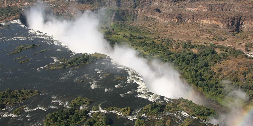 A dramatic single-drop waterfall, plunging into a deep gorge on the border.