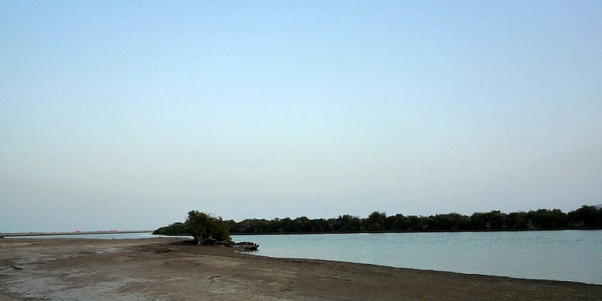 An image of the scenic Kalba Lake, which is surrounded by lush greenery and mountains.