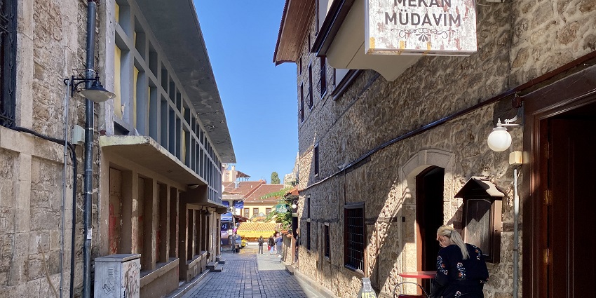 A picture of Kaleiçi's narrow cobblestone streets lined with historic houses and shops.
