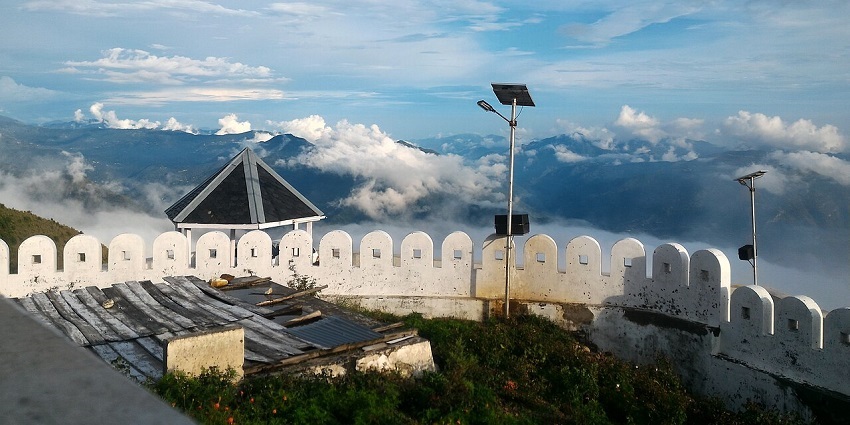 Kali ka tibba with a solar panel on top of a streetlight and hills covered in clouds