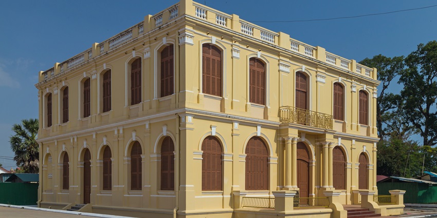 An external view of a museum with yellow walls and traditional architecture