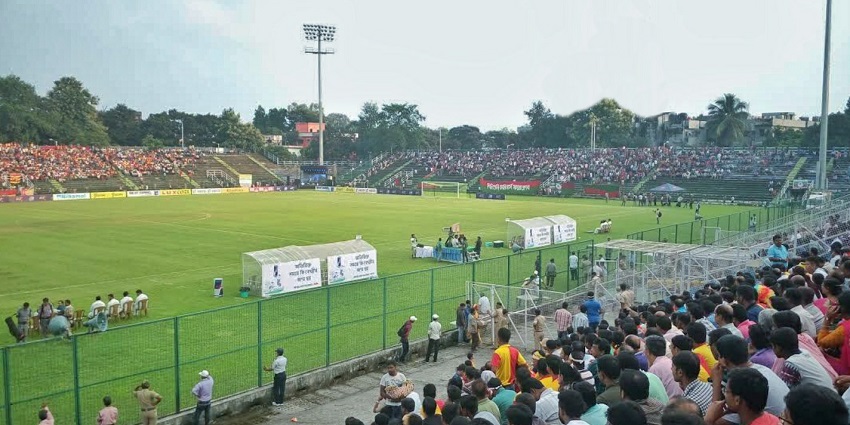 An image of the Kanchenjunga Stadium, hosting a football match, with stands full of crowd