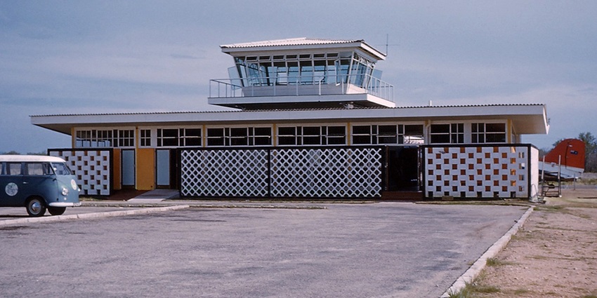 Kariba Airport with a small bus parked on the left, capturing a quiet moment at the terminal
