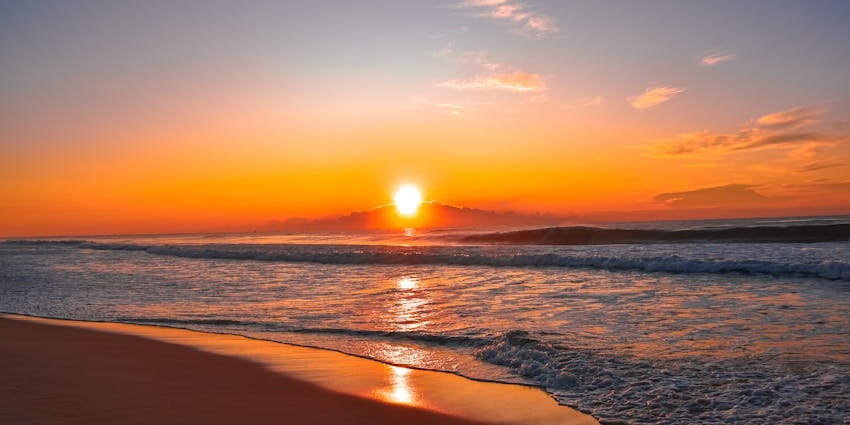Sunset at Kelan, one of the best beaches near Kuta, with waves gently touching the shore.