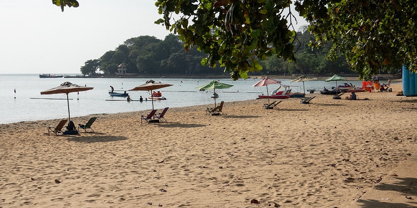 image of Kep Beach, a popular destination near Kampot, with its sandy shore and waves.