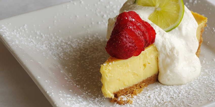 An image of key lime pie with whipped cream on top, one of the famous foods in the USA.