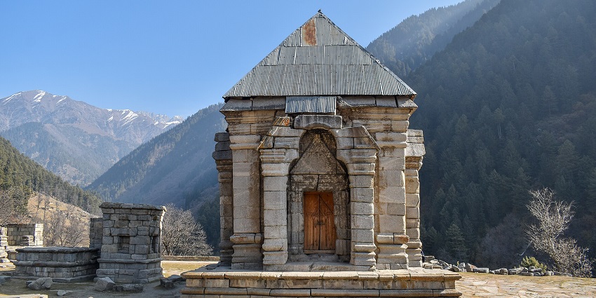 The sacred Kheer Bhawani Temple is surrounded by tall chinar trees and a peaceful pond.