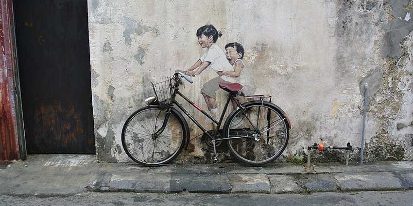 This iconic Penang street art mural captures childhood joy with 3D interaction.