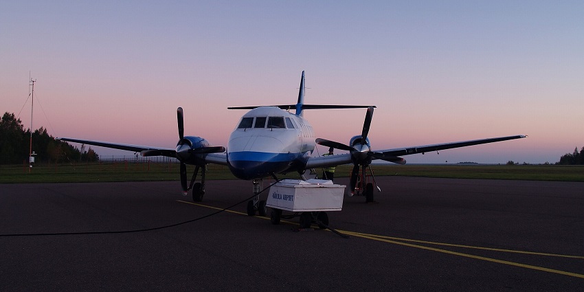 Avies Jetstream aircraft on the runway, silhouetted against a stunning golden sunset sky