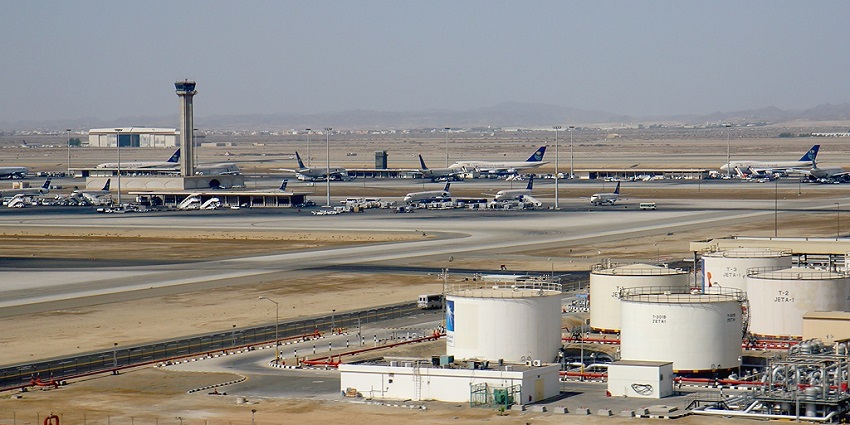 King Abdulaziz International Airport from a distance and multiple aeroplanes parked on the runway