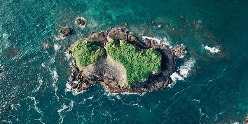 Aerial view of a green Kiriwina island, a popular destination near Trobriand Islands.