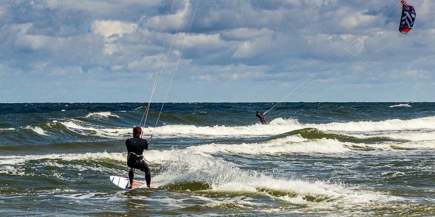View of a man enjoying kitesurfing, a famous adventure sports in the world for all beach lovers