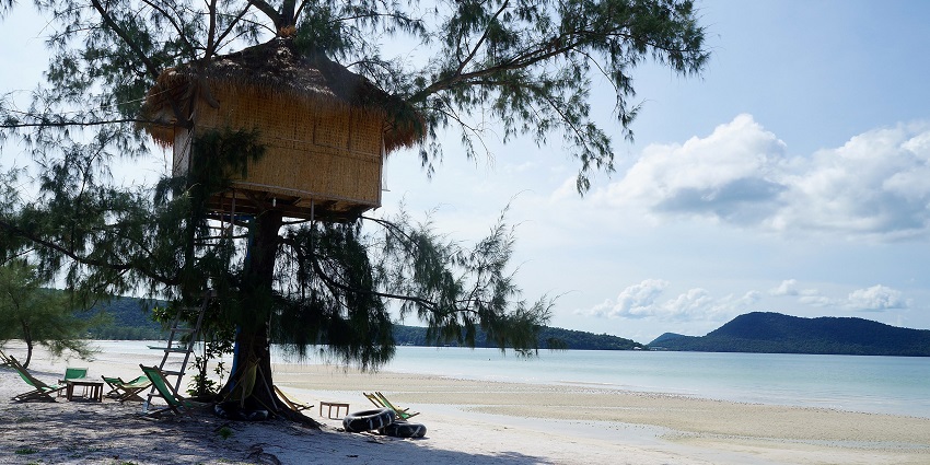 A serene view of a beach tree house and crystal-clear waters of Koh Rong Samloem.
