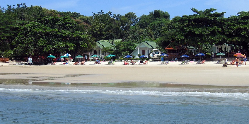 Stunning white sandy beach of Koh Samet, with crystal-clear waters and lush green surroundings.