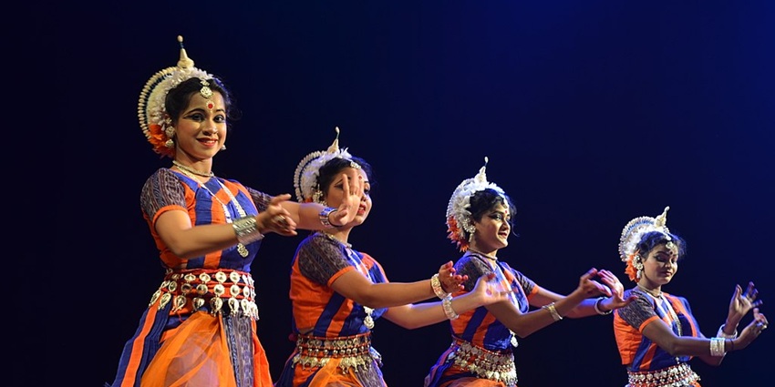 A stunning image of classical Odissi dancers performing at the Konark Festival