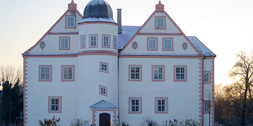 Königs Wusterhausen Palace with windows and unique architecture surrounded by snow.