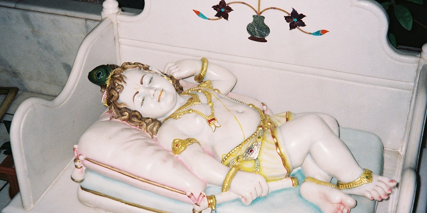 An image showing the statue of baby Krishna during Janmashtami celebrations.